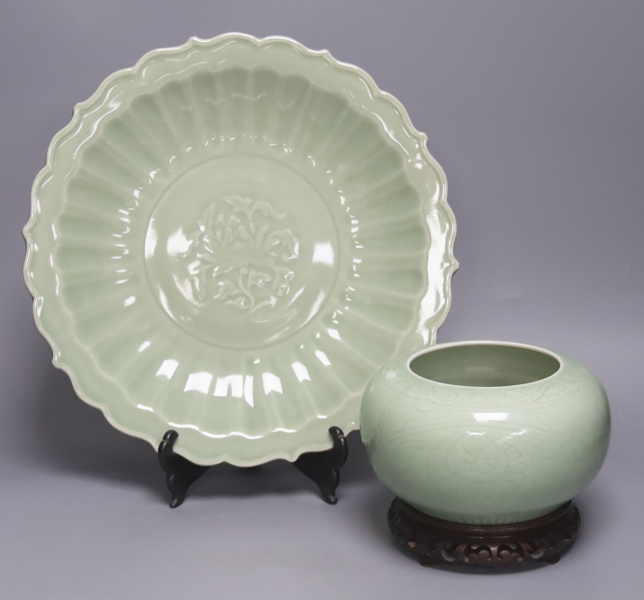 A Chinese circular celadon dish with scalloped rim, diameter 36cm, and a similar bowl, both with stands